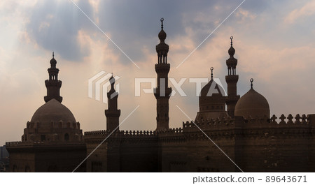 Silhouette shot of minarets and domes of  Sultan Hasan and Al Rifai Mosques, Old Cairo, Egypt 89643671