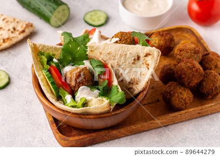 Falafel and fresh vegetables in pita bread Falafel and fresh vegetables in pita bread 89644279