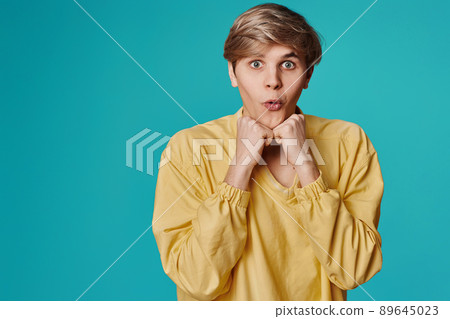 handsome guy grimacing on a dark gray background 89645023