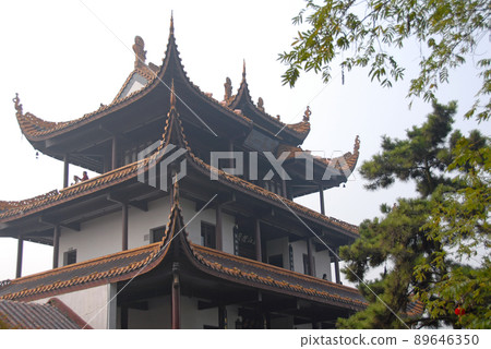 Changsha, Hunan Province, China: Tianxin Pavilion is an old Chinese pavilion located on the ancient city wall of Changsha, Hunan. View of the main pavilion from below with trees.  89646350