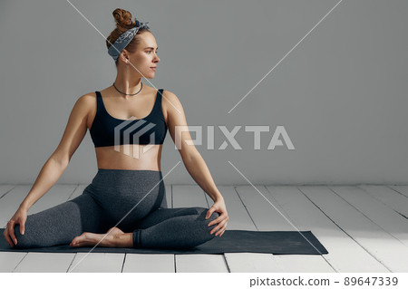 Full Body Portrait Of Pregnant Woman Doing Yoga On Exercise Mat. Isolated on gray background 89647339