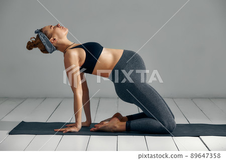 Beautiful pregnant woman workout. Doing fitness on last months of pregnancy. Yoga positions. 89647358