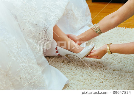 Wedding preparation. Girlfriends of the bride help her in my shoes marriage 89647854