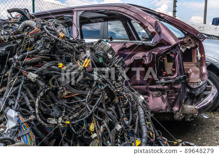 dismantling of a car into spare parts at a junkyard dismantling of a car into spare parts at a junkyard 89648279