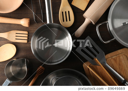Different kitchen utensil on wooden background, top view Different kitchen utensil on wooden background, top view 89649869