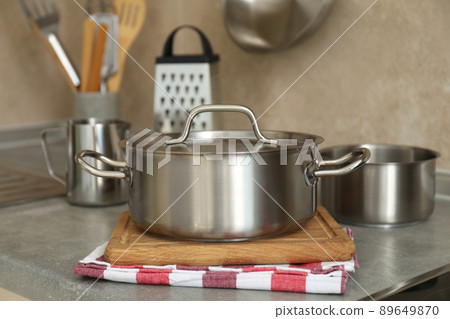 Concept of kitchen utensil with metal pot, selective focus Concept of kitchen utensil with metal pot, selective focus 89649870