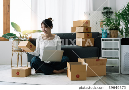 Portrait of Starting small businesses SME owners female entrepreneurs working on receipt box and check online orders to prepare to pack the boxes, sell to customers, SME business ideas online Portrait of Starting small businesses SME owners female entrepreneurs working on receipt box and check online orders to prepare to pack the boxes, sell to customers, SME business ideas online 89649873