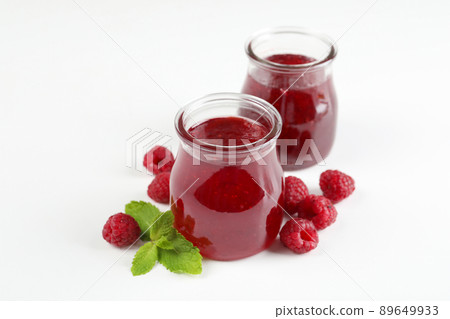 Jars of raspberry jam with ingredients on  white background 89649933