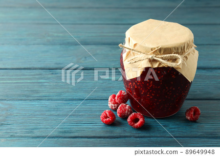 Jar of raspberry jam with ingredients on wooden background Jar of raspberry jam with ingredients on wooden background 89649948