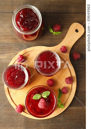 Concept of tasty food with raspberry jam on wooden background Concept of tasty food with raspberry jam on wooden background 89649968