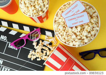 Concept of cinema accessories on yellow background Concept of cinema accessories on yellow background 89650123