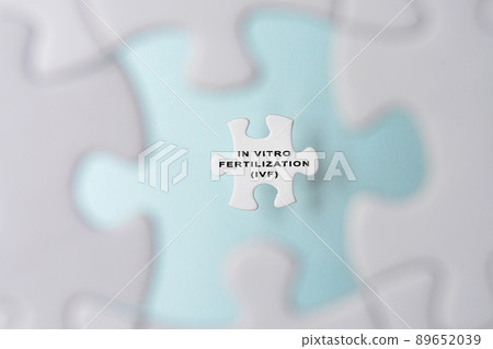 In Vitro Fertilization IVF word on puzzle pieces isolated on blue background. 89652039