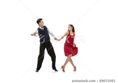 Beautiful girl and stylish man in vintage retro style outfits dancing isolated on white background. Timeless traditions, 60s,70s american fashion style and art Beautiful girl and stylish man in vintage retro style outfits dancing isolated on white background. Timeless traditions, 60s,70s american fashion style and art 89652093