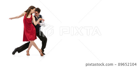 Beautiful girl and stylish man in vintage retro style outfits dancing isolated on white background. Timeless traditions, 60s,70s american fashion style and art Beautiful girl and stylish man in vintage retro style outfits dancing isolated on white background. Timeless traditions, 60s,70s american fashion style and art 89652104