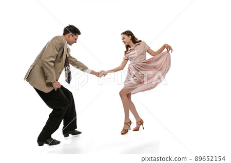 Young man and woman in vintage retro style outfits dancing social dance isolated on white background. Timeless traditions, 1960s american fashion style and art Young man and woman in vintage retro style outfits dancing social dance isolated on white background. Timeless traditions, 1960s american fashion style and art 89652154