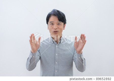 A middle-aged man who spreads his hands on a white background 89652892