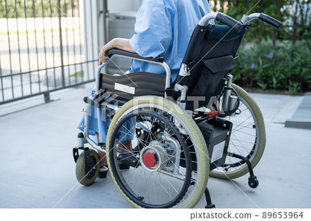 Asian senior or elderly old lady woman patient on electric wheelchair with remote control at nursing hospital ward, healthy strong medical concept 89653964