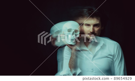 abstract blurry portrait of a psychopathic man with mental disorders with a human skull 89654929