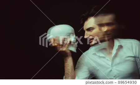 portrait of a psychopathic man with mental disorders with a human skull in hand 89654930