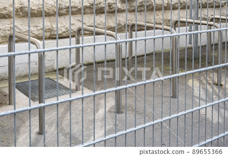 Secured parking for bikes and bicycles with a fence 89655366