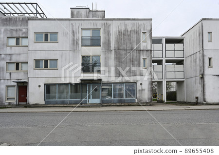 old concrete house in a residential area old concrete house in a residential area 89655408
