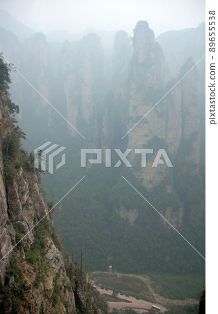 Zhangjiajie National Forest Park, Hunan Province, China: Misty mountains and forest scenery in Zhangjiajie. This Chinese national park is famous for its tall rocky pinnacles, trees and swirling mist. Zhangjiajie National Forest Park, Hunan Province, China: Misty mountains and forest scenery in Zhangjiajie. This Chinese national park is famous for its tall rocky pinnacles, trees and swirling mist. 89655538