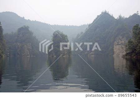 Zhangjiajie National Forest Park, Hunan Province, China: Baofeng Lake and misty mountains in Zhangjiajie. This Chinese national park is famous for its tall rocky pinnacles, trees and swirling mist. Zhangjiajie National Forest Park, Hunan Province, China: Baofeng Lake and misty mountains in Zhangjiajie. This Chinese national park is famous for its tall rocky pinnacles, trees and swirling mist. 89655543