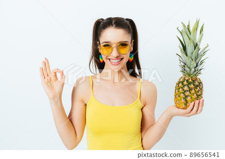 Cheerful smiling young woman in yellow sunglasses Cheerful smiling young woman in yellow sunglasses 89656541