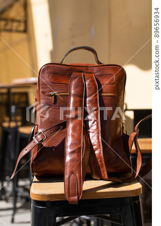 Orange leather backpack. Street photo. Natural light 89656934