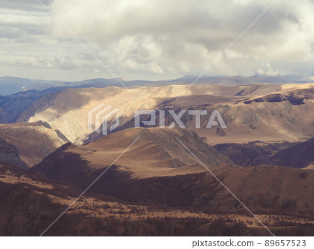 Autumn Caucasian mountain valley illuminated by the sun's rays peeping through the clouds. Countryside of Kislovodsk Autumn Caucasian mountain valley illuminated by the sun's rays peeping through the clouds. Countryside of Kislovodsk 89657523