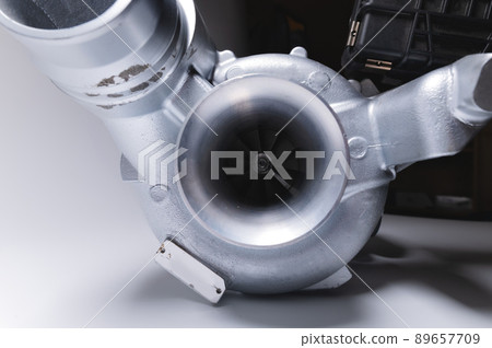 New turbocharger with aluminum cold section. on a gray contrasting background. car engine turbocharger. spare parts 89657709