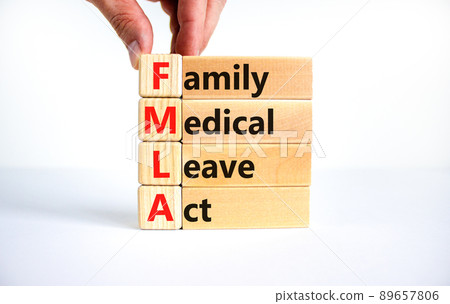FMLA family medical leave act symbol. Concept words FMLA family medical leave act on wooden blocks on a beautiful white background. Doctor hand. Medical FMLA family medical leave act concept. FMLA family medical leave act symbol. Concept words FMLA family medical leave act on wooden blocks on a beautiful white background. Doctor hand. Medical FMLA family medical leave act concept. 89657806