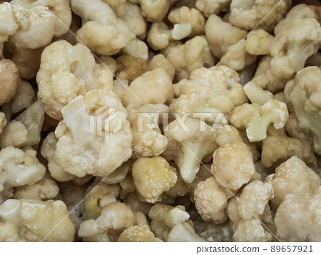 Frozen white broccoli in the refrigerator in the store 89657921