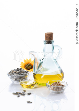Sunflower oil and sunflower seeds isolated on white background with copyspace. Vertical format. 89658494