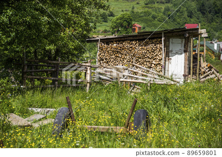 wooden shed for storing firewood in Ukrainian village wooden shed for storing firewood in Ukrainian village 89659801
