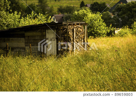 wooden shed for storing firewood in Ukrainian village wooden shed for storing firewood in Ukrainian village 89659803