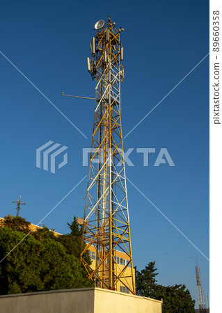 Radio transmitting TV tower with transmitters against the blue sky. 89660358