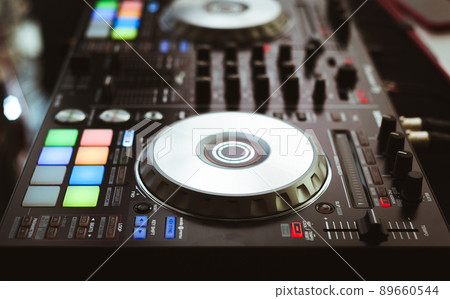 DJ plays and mix music on digital midi controller 89660544
