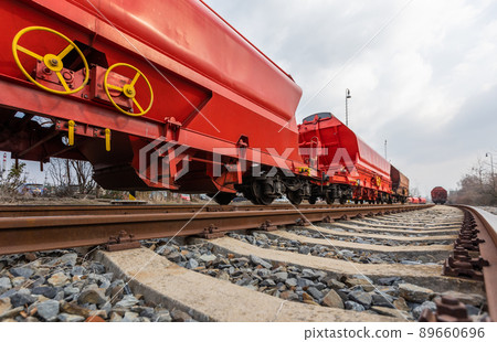 Train wagons carrying freight containers for shipping companies. distribution and freight transport by a railway, transport concept Train wagons carrying freight containers for shipping companies. distribution and freight transport by a railway, transport concept 89660696