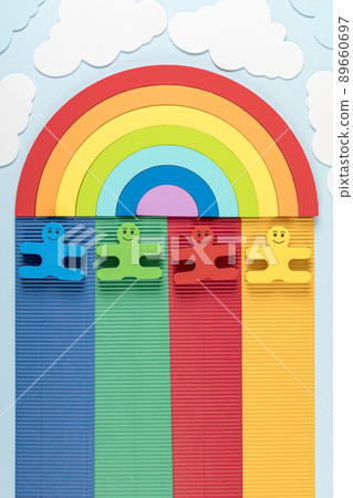International Children's Day concept. Rainbow with wooden toys of children on the blue background. International Children's Day concept. Rainbow with wooden toys of children on the blue background. 89660697