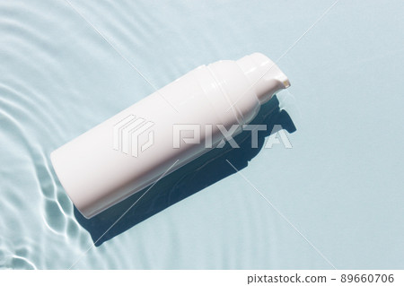 White cosmetic tubes on the water surface. Blank label for branding mock-up. Summer vacation cosmetics concept. White cosmetic tubes on the water surface. Blank label for branding mock-up. Summer vacation cosmetics concept. 89660706