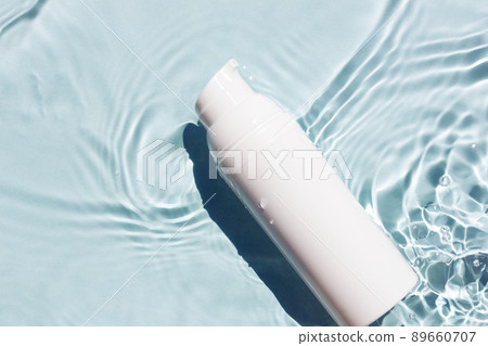 White cosmetic tubes on the water surface. Blank label for branding mock-up. Summer vacation cosmetics concept.  89660707