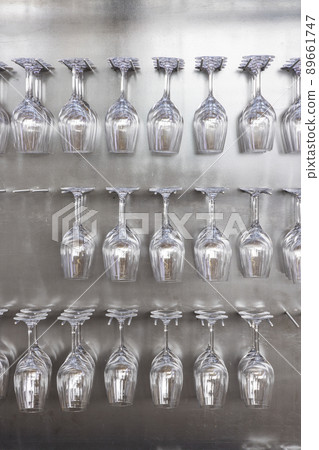 Wine glasses hanging on wall in wine shop Wine glasses hanging on wall in wine shop 89661747