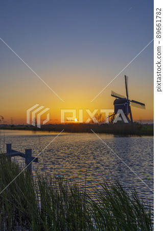 Sunset with windmill Broekmolen, Molenlanden - Nieuwpoort, The Netherlands Sunset with windmill Broekmolen, Molenlanden - Nieuwpoort, The Netherlands 89661782