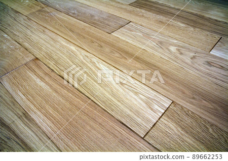 Natural light brown wooden parquet floor boards. Sunny soft yellow texture, copy space perspective background. Natural light brown wooden parquet floor boards. Sunny soft yellow texture, copy space perspective background. 89662253