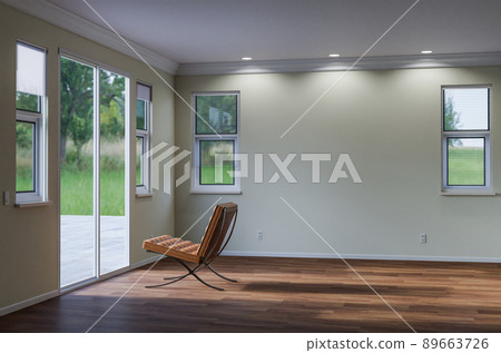 Empty Chair Sitting on the Floor Facing Glass Door in Empty Room of House with Blank Wall. Empty Chair Sitting on the Floor Facing Glass Door in Empty Room of House with Blank Wall. 89663726