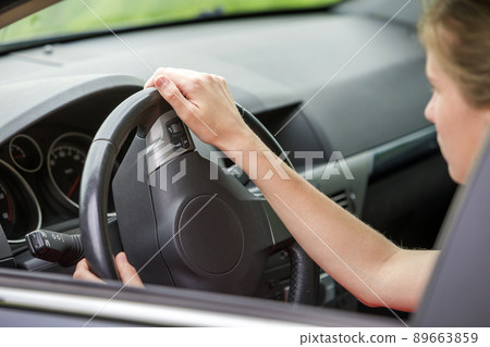 Car interior. Dashboard and woman hands on steering wheel driving a car. Car interior. Dashboard and woman hands on steering wheel driving a car. 89663859