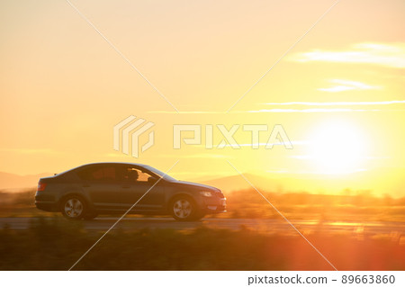 Car driving fast on intercity road at sunset. Highway traffic in evening. Kyiv, Ukraine - June 8, 2021. Car driving fast on intercity road at sunset. Highway traffic in evening. Kyiv, Ukraine - June 8, 2021. 89663860