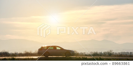 Car driving fast on intercity road at sunset. Highway traffic in evening. Kyiv, Ukraine - June 8, 2021. 89663861