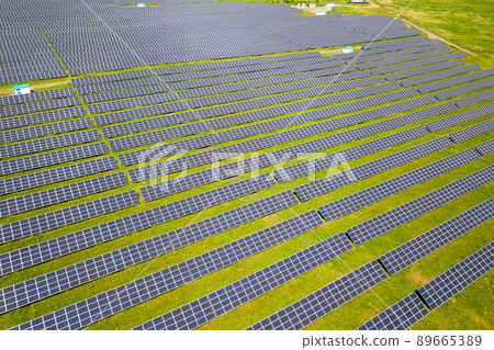 Aerial view of solar power plant on green field. Electric panels for producing clean ecologic energy. Aerial view of solar power plant on green field. Electric panels for producing clean ecologic energy. 89665389